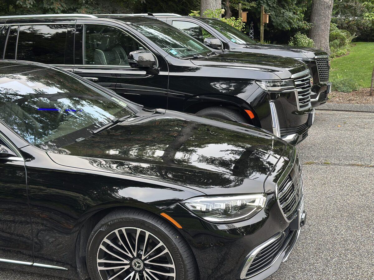 Mercedes S-Class and Cadillac Escalade parked together